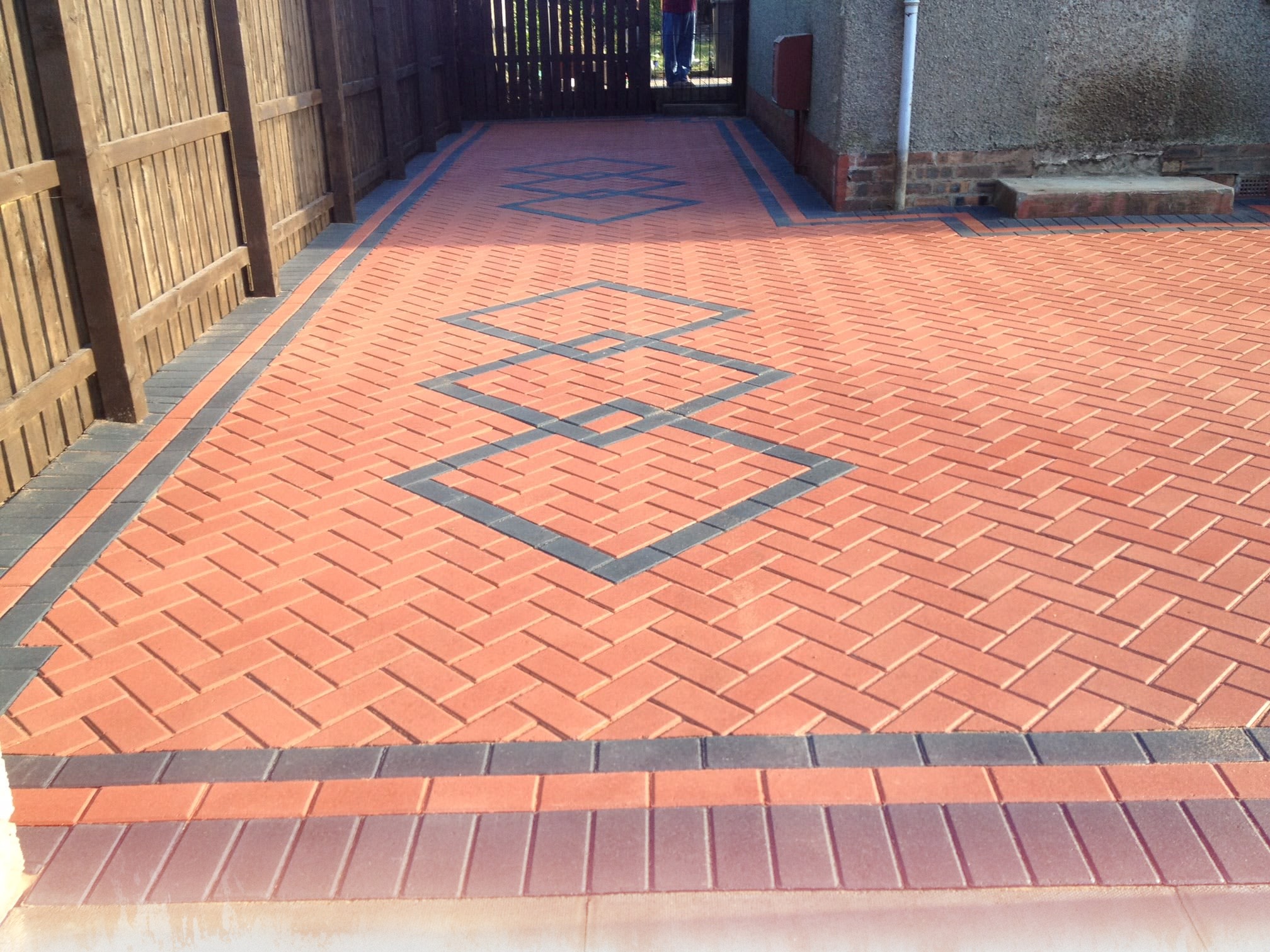 Red monoblock driveway with charcoal diamond inlay detail