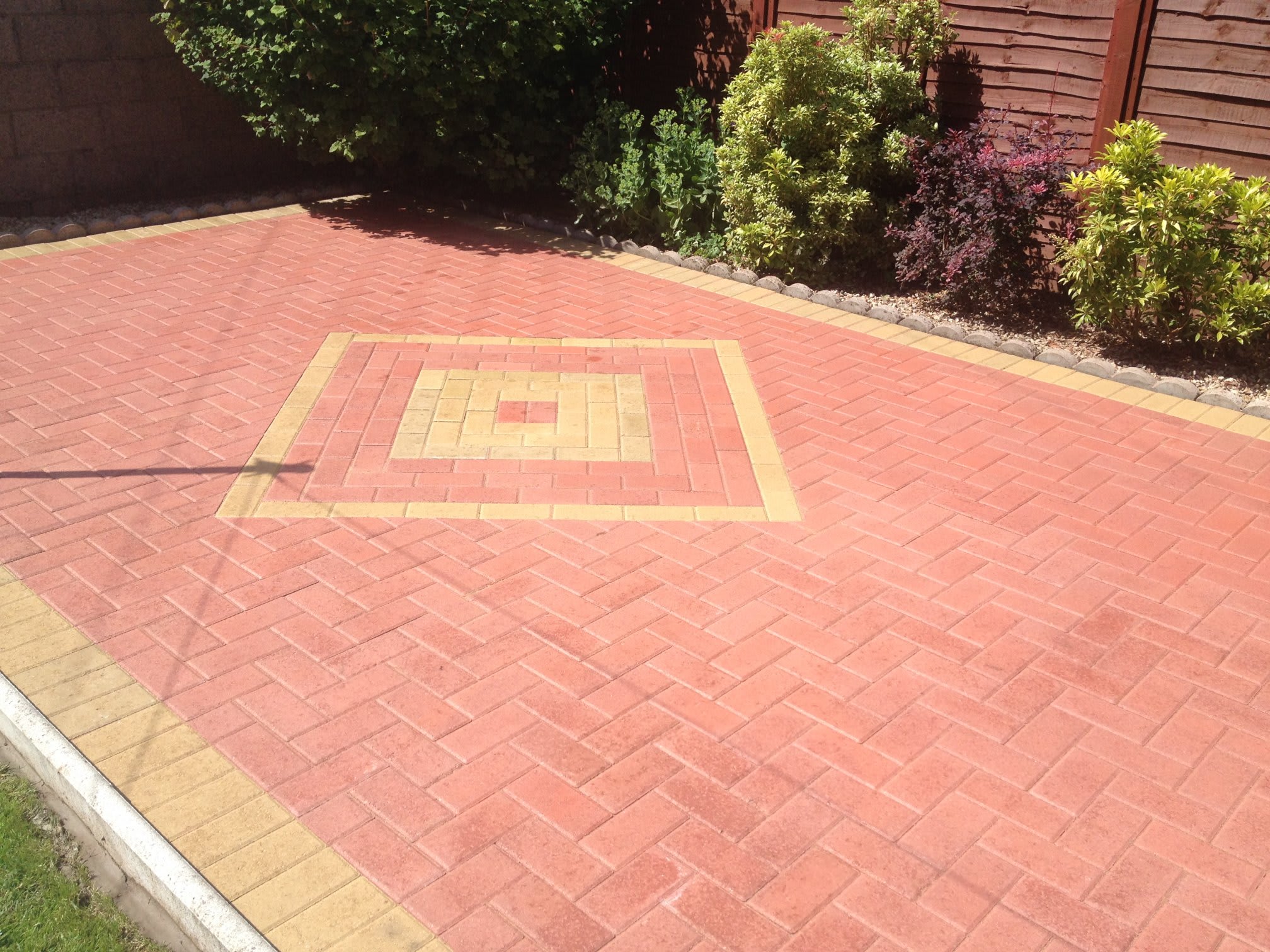 Red block paving with a feature centre panel